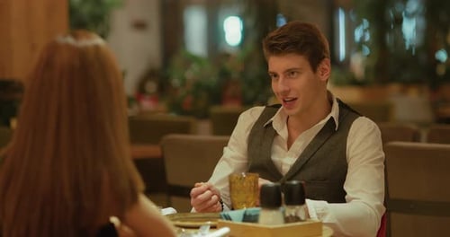 Young Handsome Man Talking to a Girl in a Restaurant a Date of People in Love