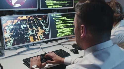 Programmers Typing Code in Modern Office at Night