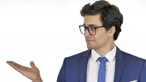 Young Businessman Showing Product on Side, White Background