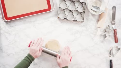 Flat lay. Step by step. Rolling out sugar cookie dough to bake Christmas cookies.