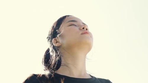 Woman Tilts Head Back to Breathe Fresh Air