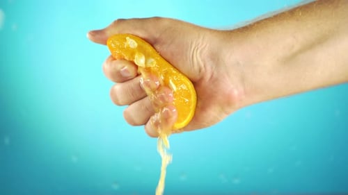Hand Squeezing Out Fresh Orange