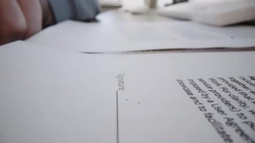 Hand Signing Legal Document at the Workplace