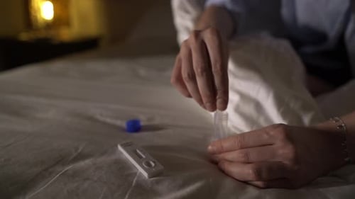 Performing Medical Self-Test on Bed at Night