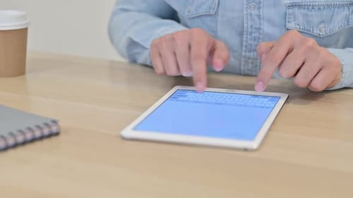 Close Up of Male Hands Typing on Tablet