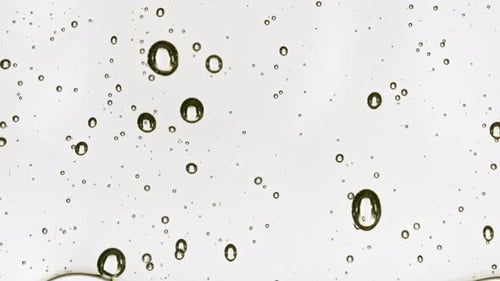 Transparent Cosmetic Gel Fluid Flowing Down on a White Surface