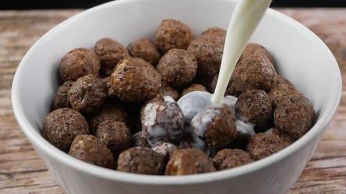 Milk Being Poured over Chocolate Cereal