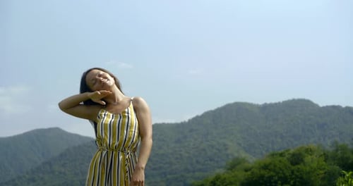 Cheerful Woman Is Dancing Outdoors in Sunny Summer Day, Rising Hands Up and Smiling