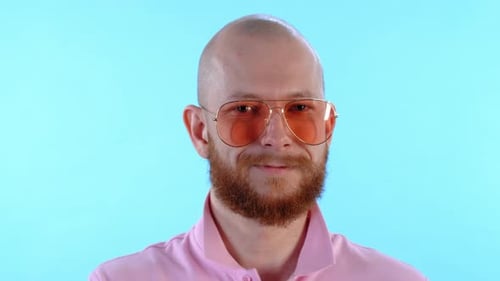 Smiling Man with Beard and Sunglasses Holding Leaf