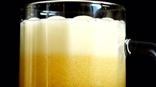 Amber Beer Being Poured into a Glass Mug