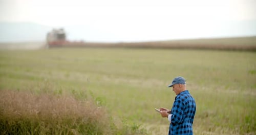 Farmer with Tablet in Rural Agricultural Field