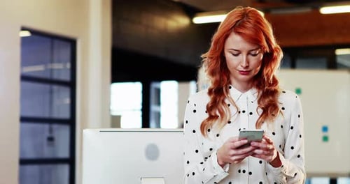 Woman Using Smartphone in Bright Modern Office