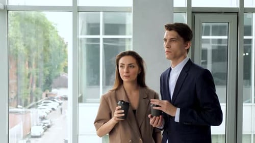 Business People Drinking Coffee By The Office Windows