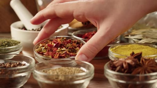 Various Dried Herbs and Spices in Small Bowls