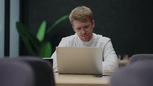Attentive Millennial Male Manager Employee Busy at Telework at Quarantine Time Study Documents in