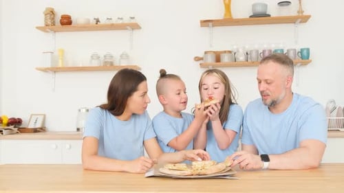 Family Enjoys Pizza Together in Bright Kitchen