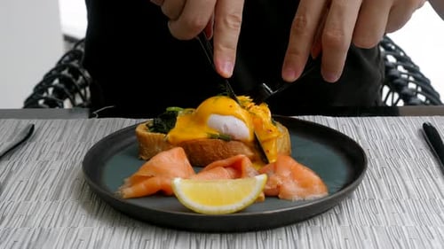 Cutting Into Eggs Benedict with Salmon and Lemon