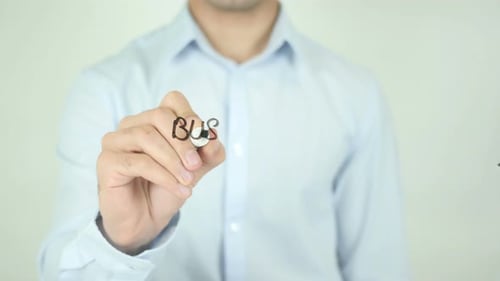 Man Writing Business Insurance on Clear Surface