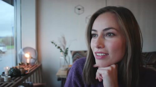 Woman Sipping Coffee In Cafe