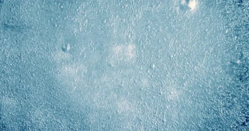 Abstract Bubbles Rising in Blue Liquid Close Up