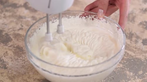 Electric Mixer Whipping Cream in Mixing Bowl. Making Cream Dessert.