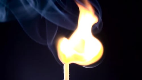 Burning Match and Flame Smoke. Slow Motion. Black Background. Close Up