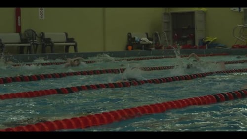Swimmers Training Laps in an Indoor Pool