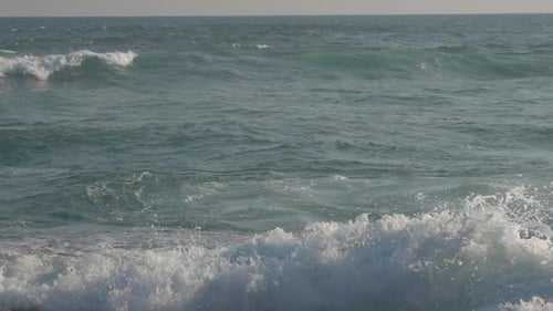 Huge Ocean Waves Roll on Beach Against Blue Sky Slow Motion
