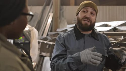 Caucasian Workman Talking to Unrecognizable Person