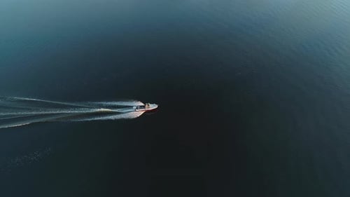 Motor Boat on River and Barge at Sunrise