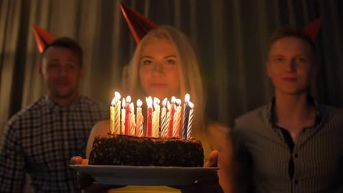 Friends Celebrate Birthday Party with Cake and Candles