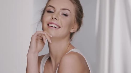 Smiling Woman with Blond Hair Posing Elegantly