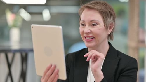 Professional Woman Using Tablet for Video Conferencing