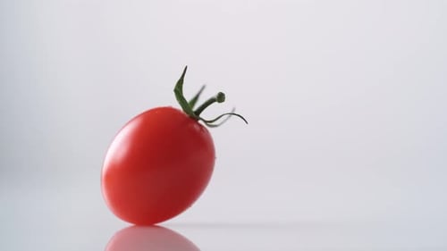 Cherry tomatos falling. Slow Motion.