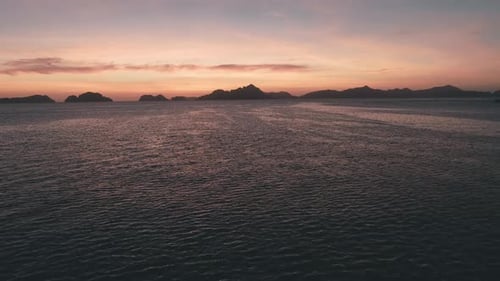 Aerial Drone View of the Sea Surface in the Light of the Golden Sunset