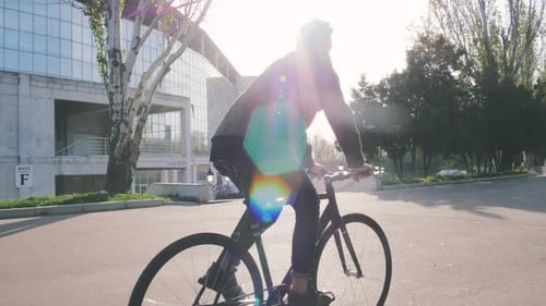 Tracking Shot of Hipster Man Riding Fixed Gear Bicycle in Park