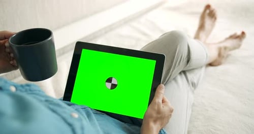 Person Relaxing with Tablet Green Screen and Mug