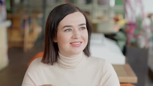 Woman Enjoys Coffee at Sunny Cafe