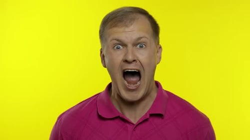 Man With Surprised Expression Against Yellow Background