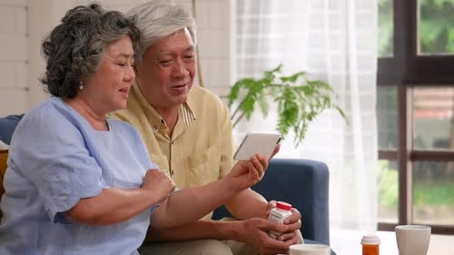 Senior Couple Using Device Together Indoors