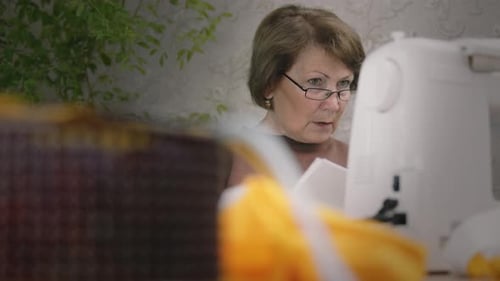 Woman Works at Sewing Machine Indoors