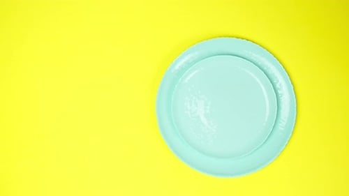 Hands Arranging Place Setting with Blue Plates