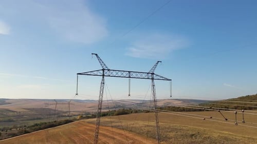 Electricity Pylon Towers Across Rural Landscape, Aerial View