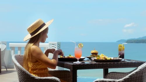Woman Dining at Tropical Ocean View Restaurant