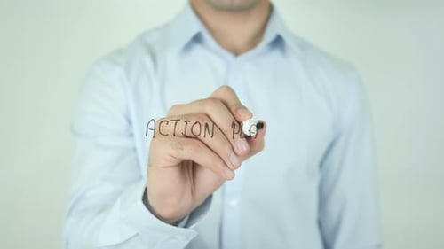 Writing Action Plan on Glass Surface