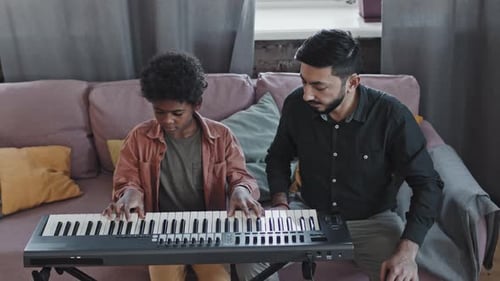 Child Receives Keyboard Lesson at Home
