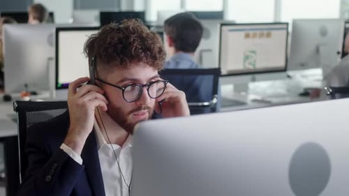 Man Working With Headset In Busy Modern Office