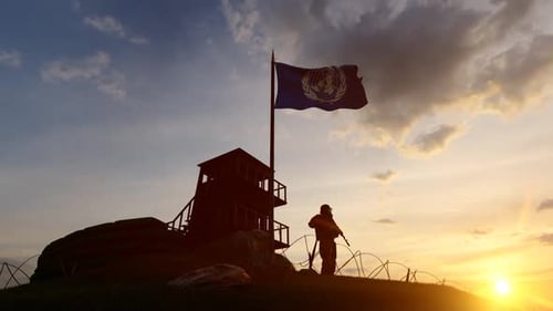 United Nations Peacekeeper Guarding at Sunset with Waving Flag