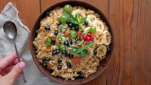 Healthy Grain Bowl Topped with Fruit and Nuts