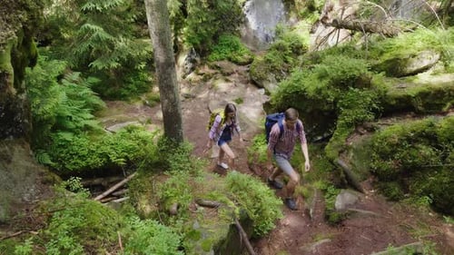 Top View: A Couple of Tourists Climb Up the Steep Path. Healthy and Active Young People Concept